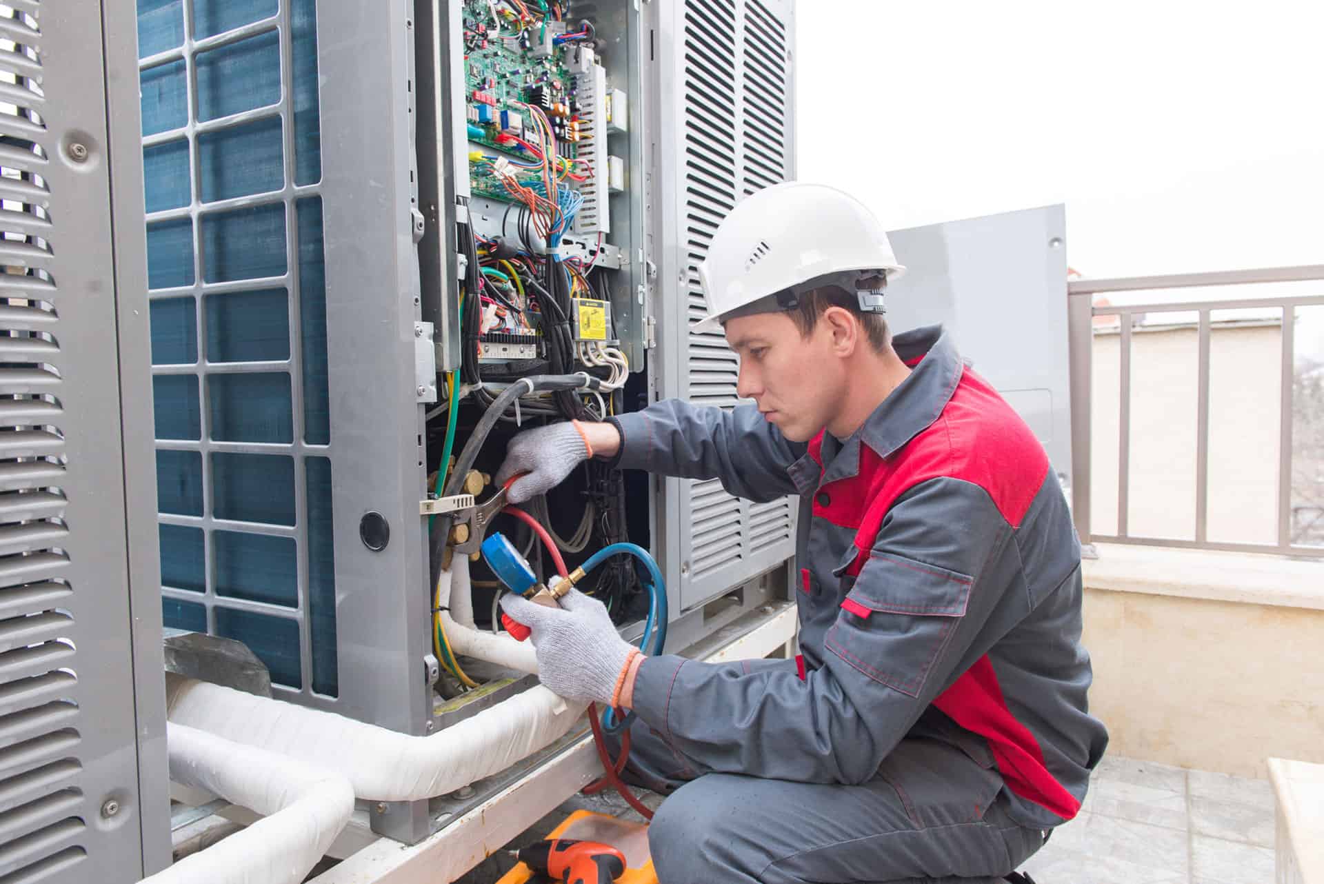 engineer maintaining air conditioning unit